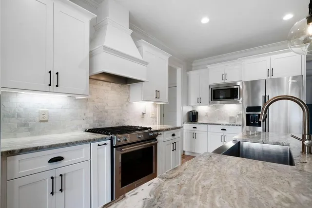 a bathroom with a granite countertop sink mirror and bathtub