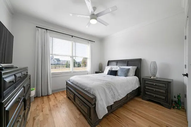 a living room with a bed furniture and a flat screen tv