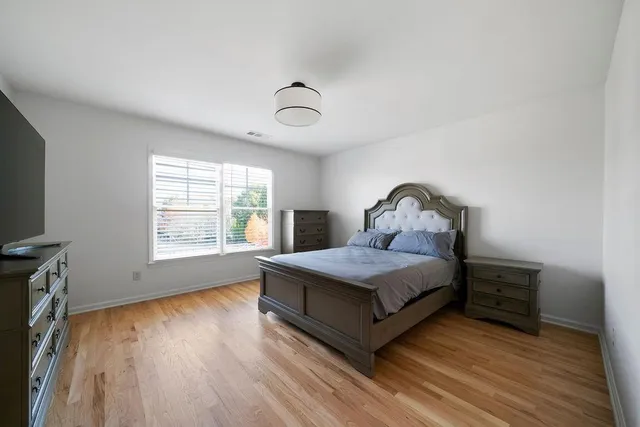 a bathroom with a granite countertop sink a toilet and a mirror