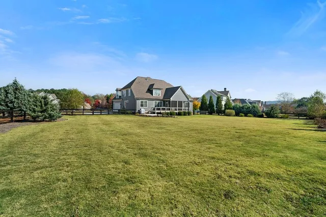 a front view of a house with a garden and deck