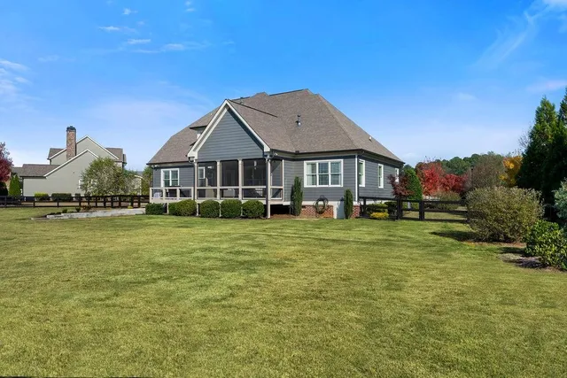 a view of a house with backyard and sitting area