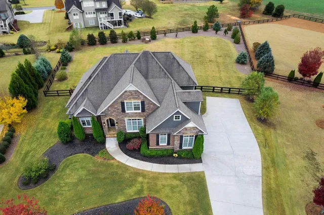 an aerial view of a house with a swimming pool