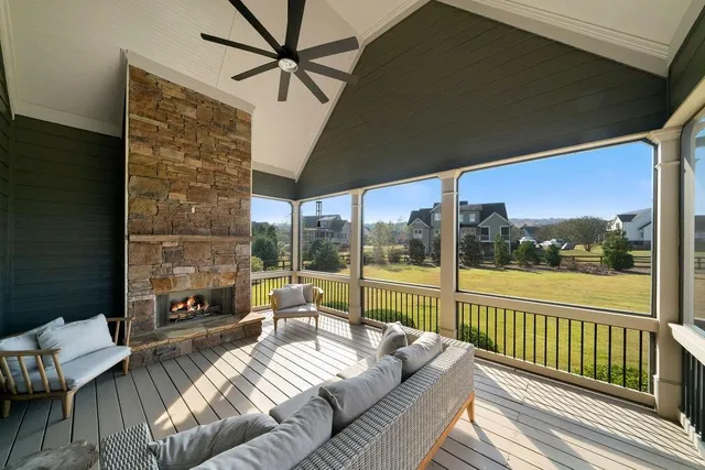a balcony with furniture and a floor to ceiling window