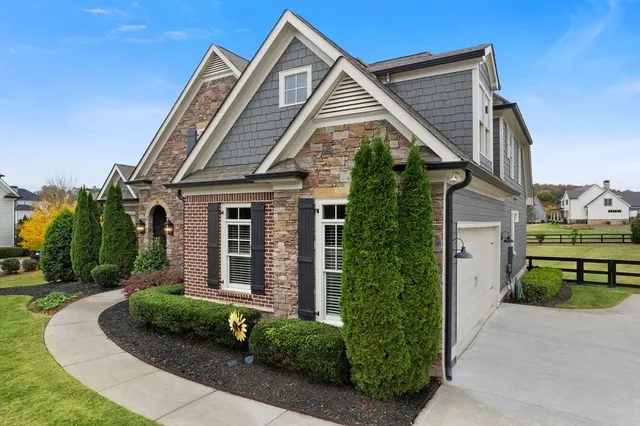a front view of a house with a garden