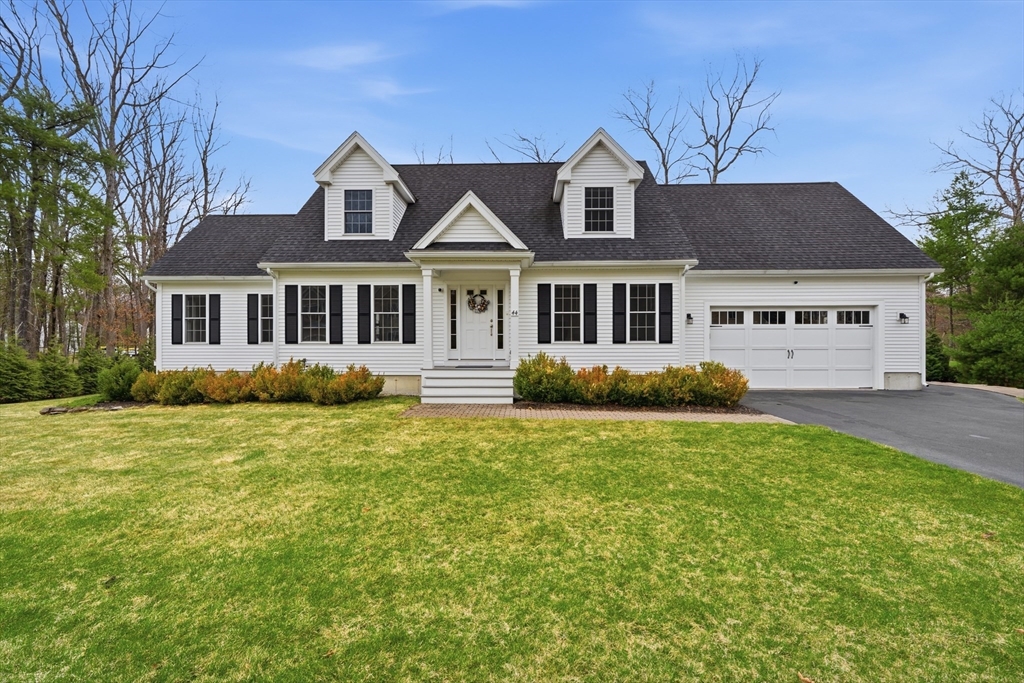 44 Bacon Street Pepperell, MA 01463 - Photo 1 of 42 a front view of a house with a garden