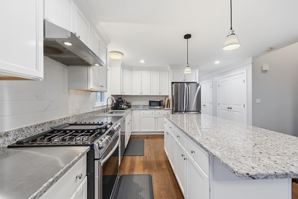 44 Bacon Street Pepperell, MA 01463 - Photo 11 of 42 a kitchen with stainless steel appliances granite countertop a sink stove and refrigerator