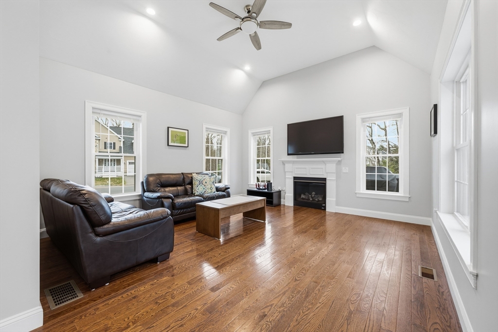 44 Bacon Street Pepperell, MA 01463 - Photo 14 of 42 a living room with furniture a fireplace and a flat screen tv