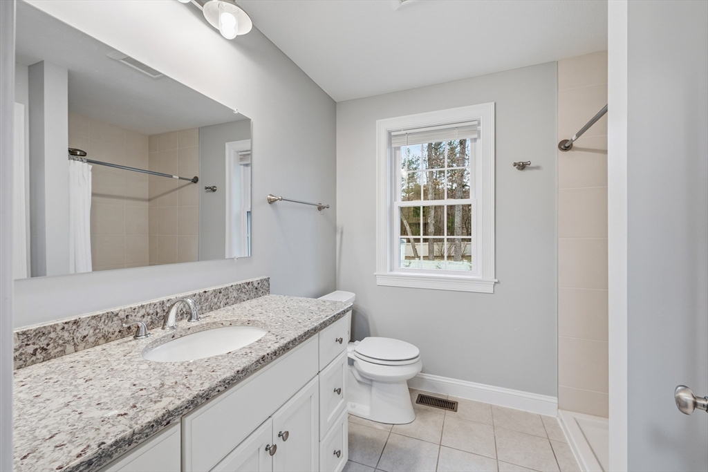 44 Bacon Street Pepperell, MA 01463 - Photo 17 of 42 a bathroom with a granite countertop sink toilet and shower