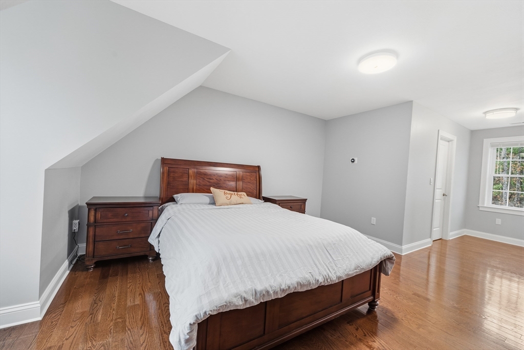 44 Bacon Street Pepperell, MA 01463 - Photo 20 of 42 a bedroom with a bed and wooden floor
