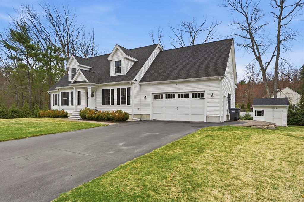 44 Bacon Street Pepperell, MA 01463 - Photo 2 of 42 a front view of a house with a yard and garage