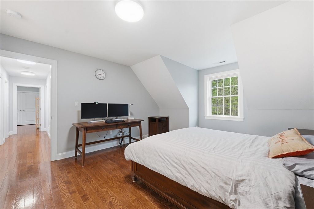 44 Bacon Street Pepperell, MA 01463 - Photo 21 of 42 a bedroom with a bed and a table in it