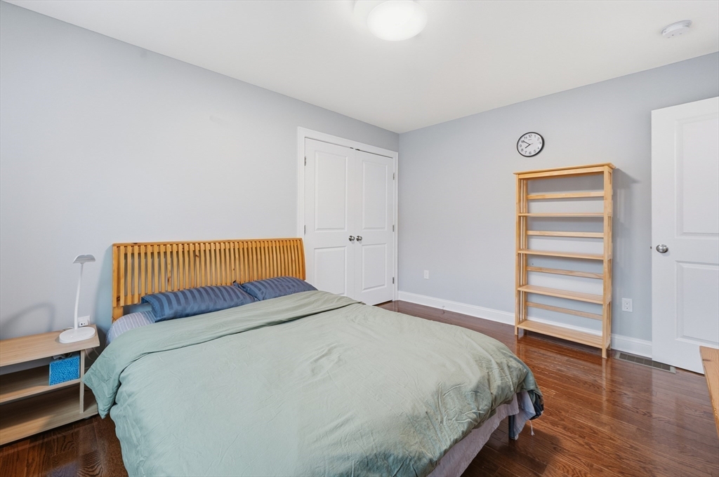 44 Bacon Street Pepperell, MA 01463 - Photo 25 of 42 a bedroom with a bed and wooden floor