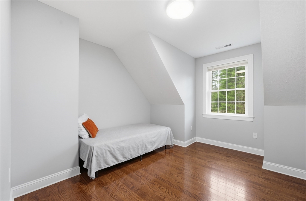 44 Bacon Street Pepperell, MA 01463 - Photo 26 of 42 a bedroom with a bed and wooden floor