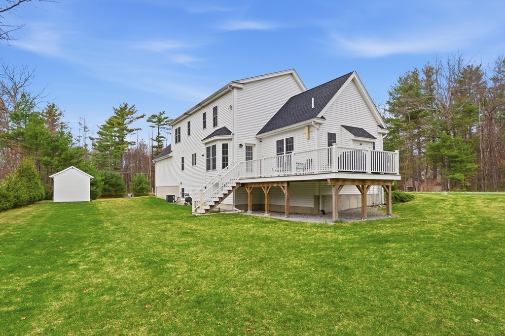 44 Bacon Street Pepperell, MA 01463 - Photo 3 of 42 a white house with a big yard and large trees