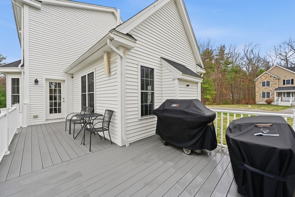 44 Bacon Street Pepperell, MA 01463 - Photo 5 of 42 a view of a patio with table and chairs with wooden floor and fence