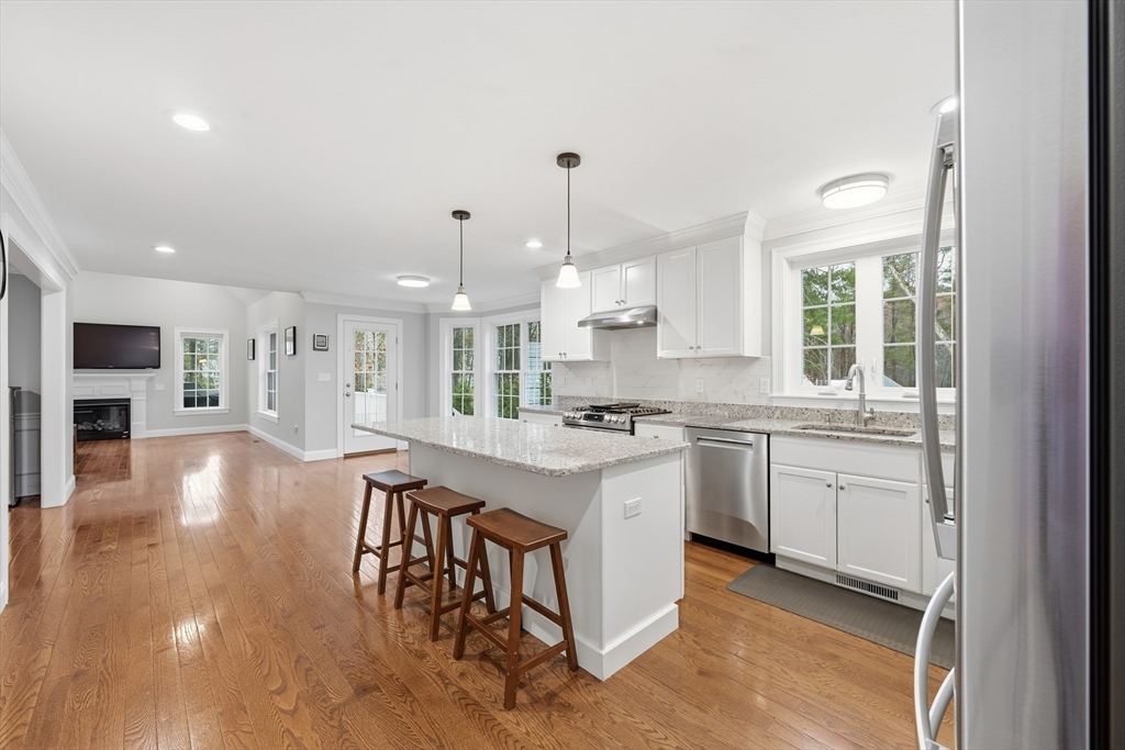44 Bacon Street Pepperell, MA 01463 - Photo 8 of 42 a kitchen with stove a sink dishwasher and a refrigerator with wooden floor