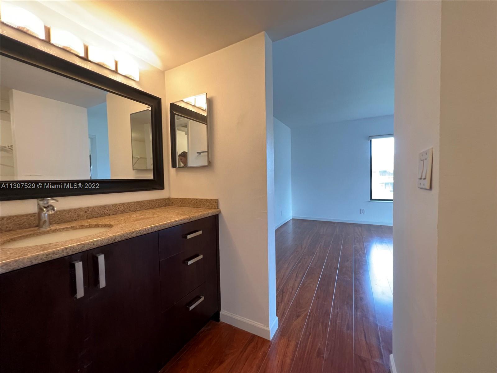 159 Northwest 70th Street, Unit 512 Boca Raton, FL 33487 - Photo 16 of 43 a bathroom with a sink and a mirror