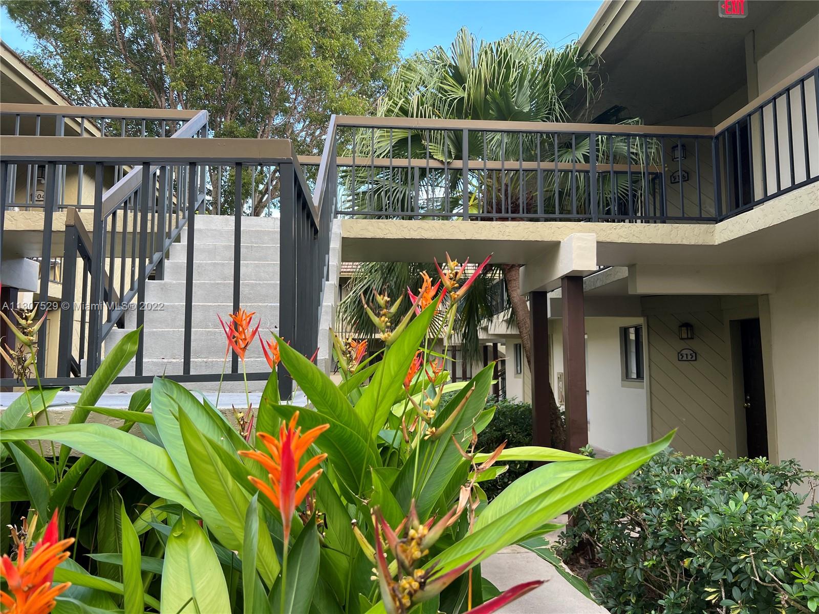 159 Northwest 70th Street, Unit 512 Boca Raton, FL 33487 - Photo 36 of 43 a view of a street with flower plants