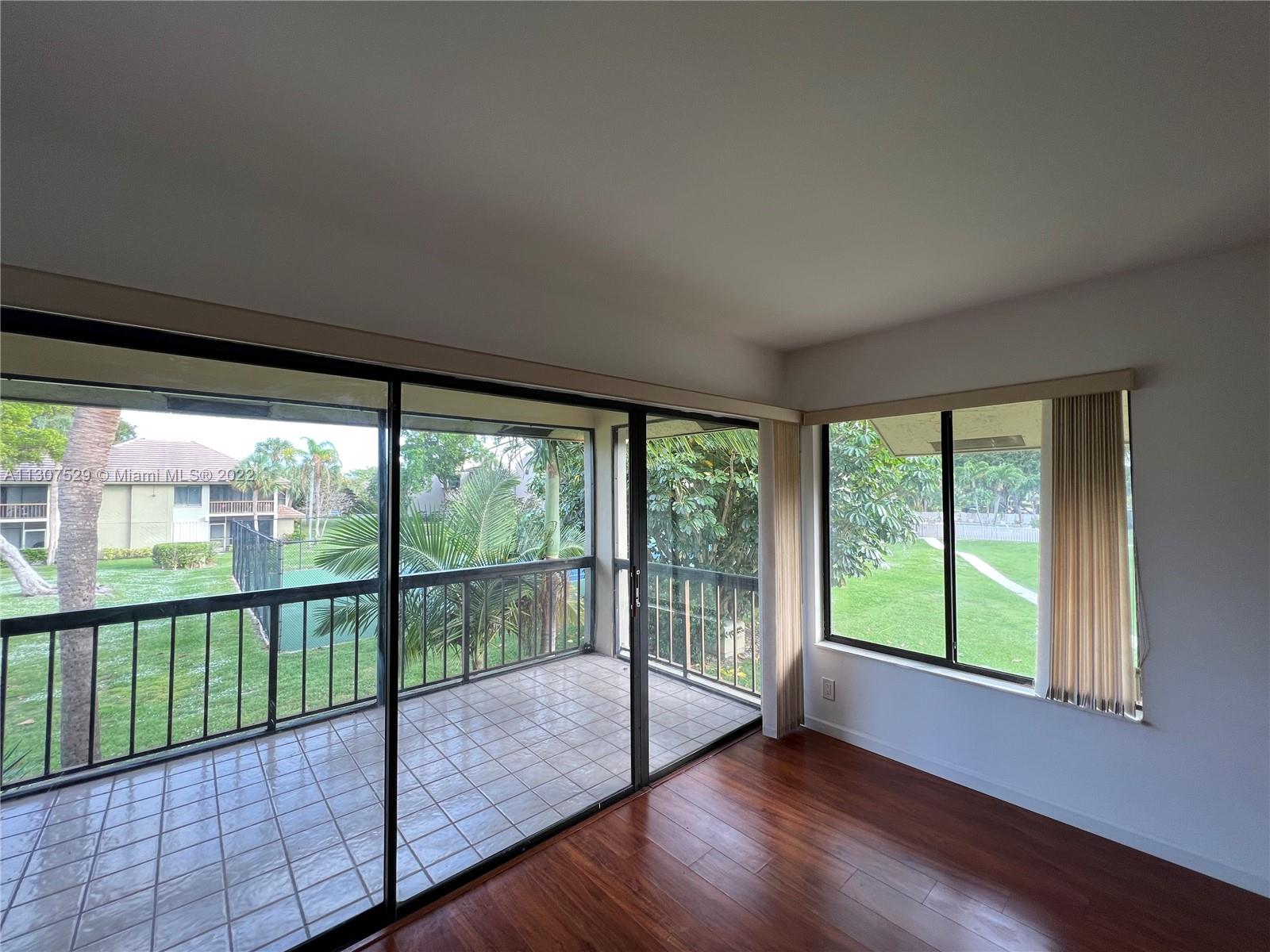 159 Northwest 70th Street, Unit 512 Boca Raton, FL 33487 - Photo 8 of 43 a view of a room with wooden floor and balcony
