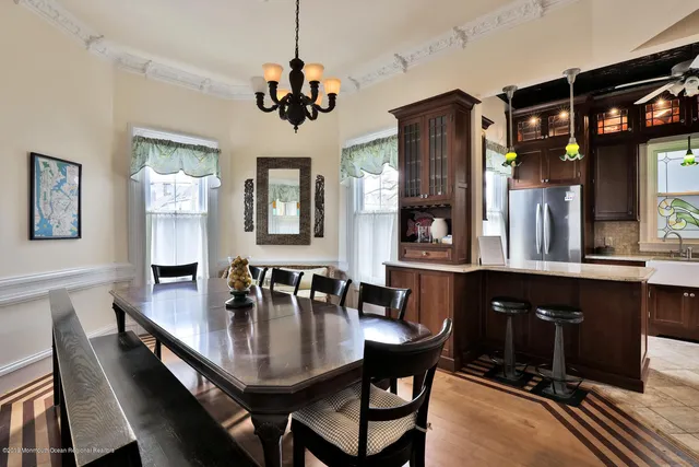 a dining room with wooden floor and breakfast area