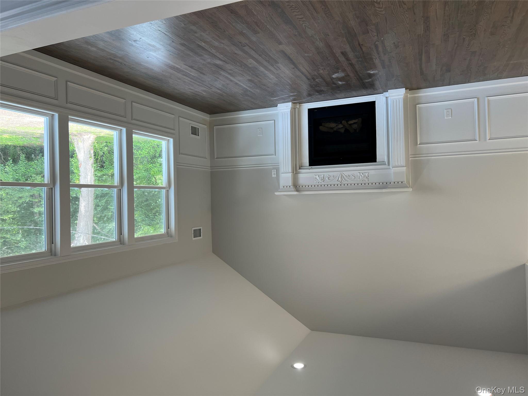 56 Aspen Road Mastic Beach, NY 11951 - Photo 3 of 13 an empty room with windows and fireplace