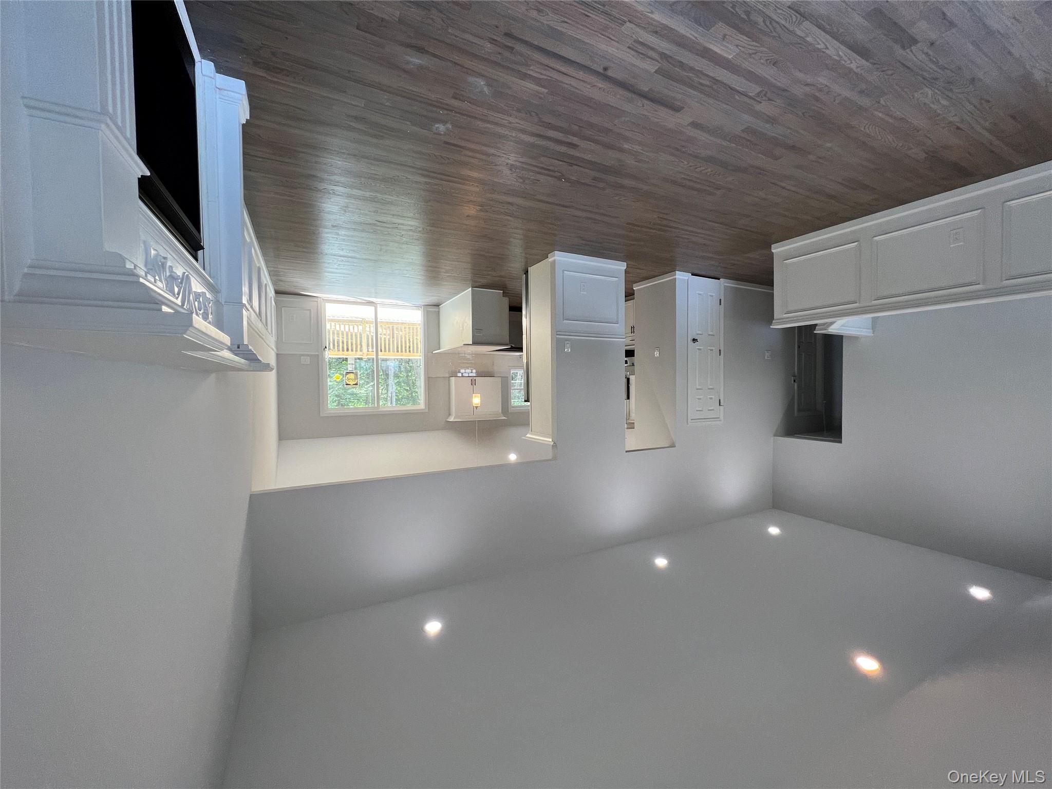 56 Aspen Road Mastic Beach, NY 11951 - Photo 6 of 13 a view of an empty room with wooden floor and a window