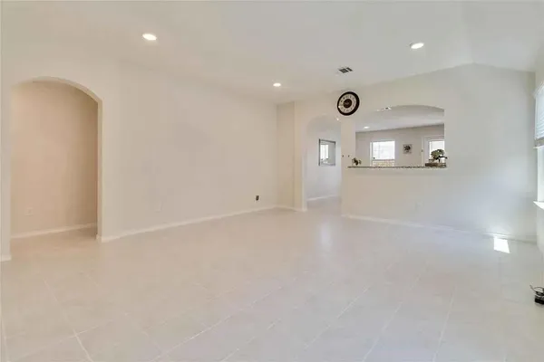 an empty room with mirror and windows