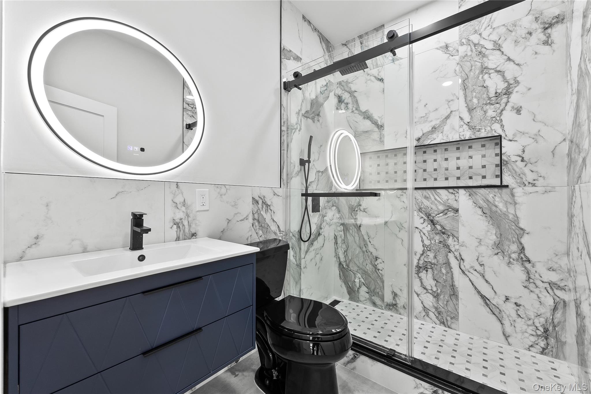 2 Orchid Road Levittown, NY 11756 - Photo 14 of 46 a bathroom with a sink a toilet and a mirror