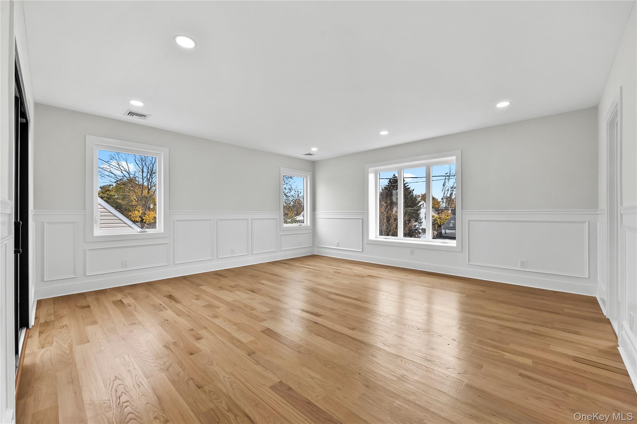 2 Orchid Road Levittown, NY 11756 - Photo 25 of 46 a view of an empty room with wooden floor and a window