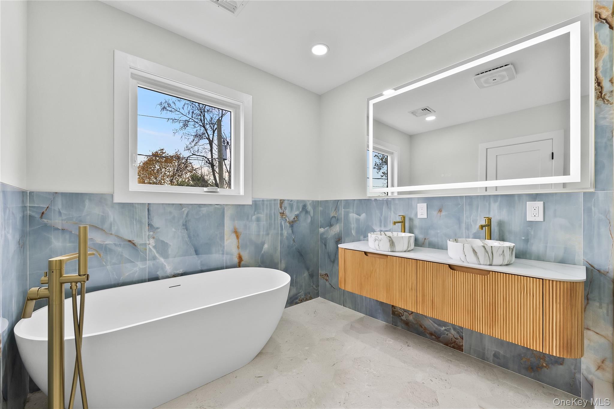 2 Orchid Road Levittown, NY 11756 - Photo 28 of 46 a bathroom with a tub a sink and mirror