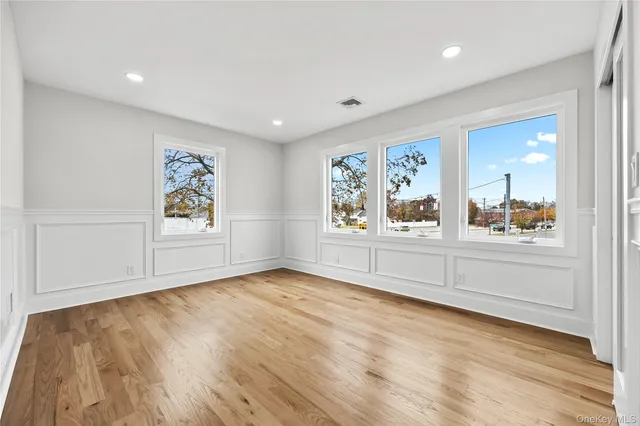 a view of a livingroom with wooden floor and window