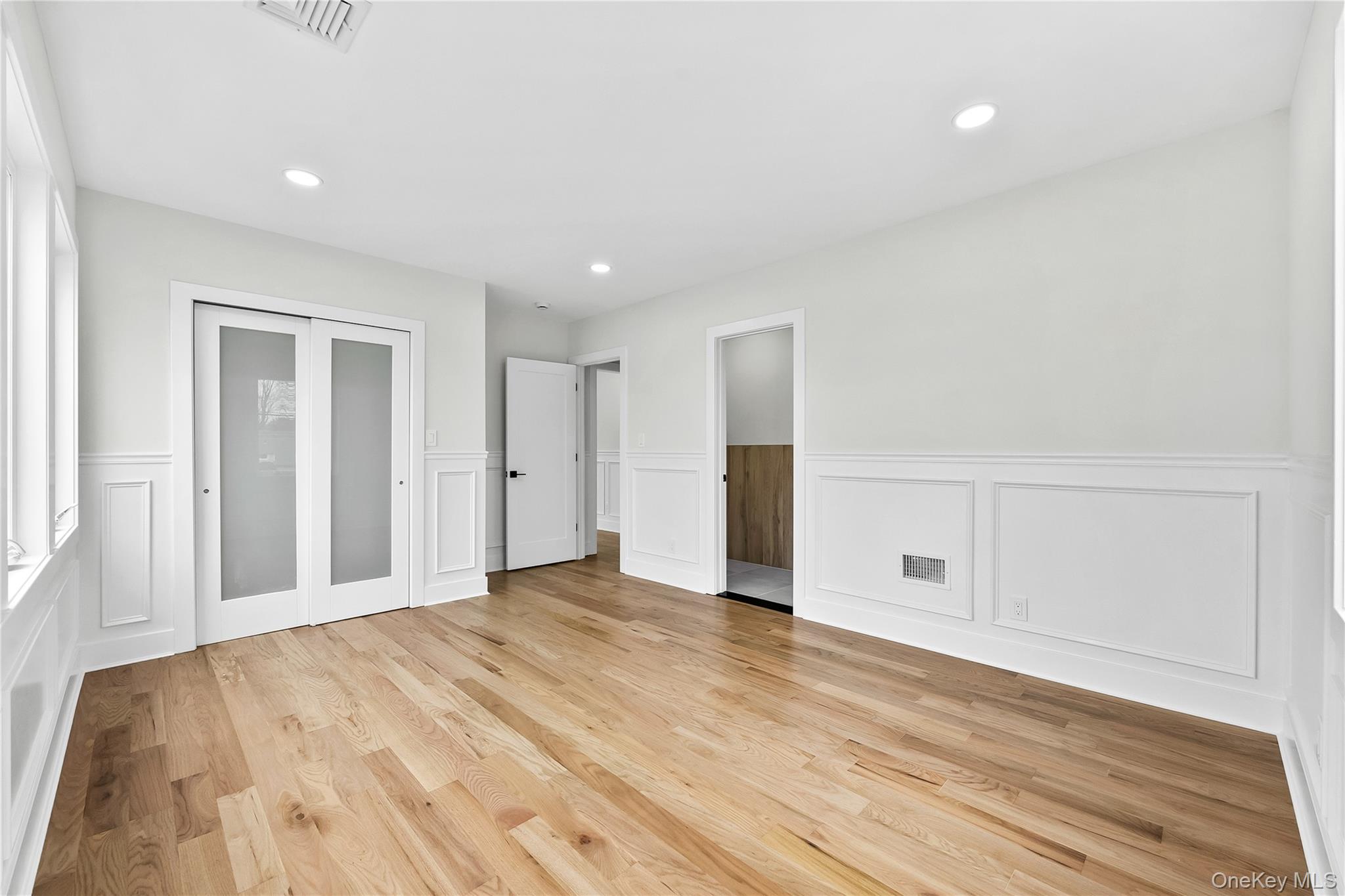 2 Orchid Road Levittown, NY 11756 - Photo 32 of 46 a view of an empty room with wooden floor