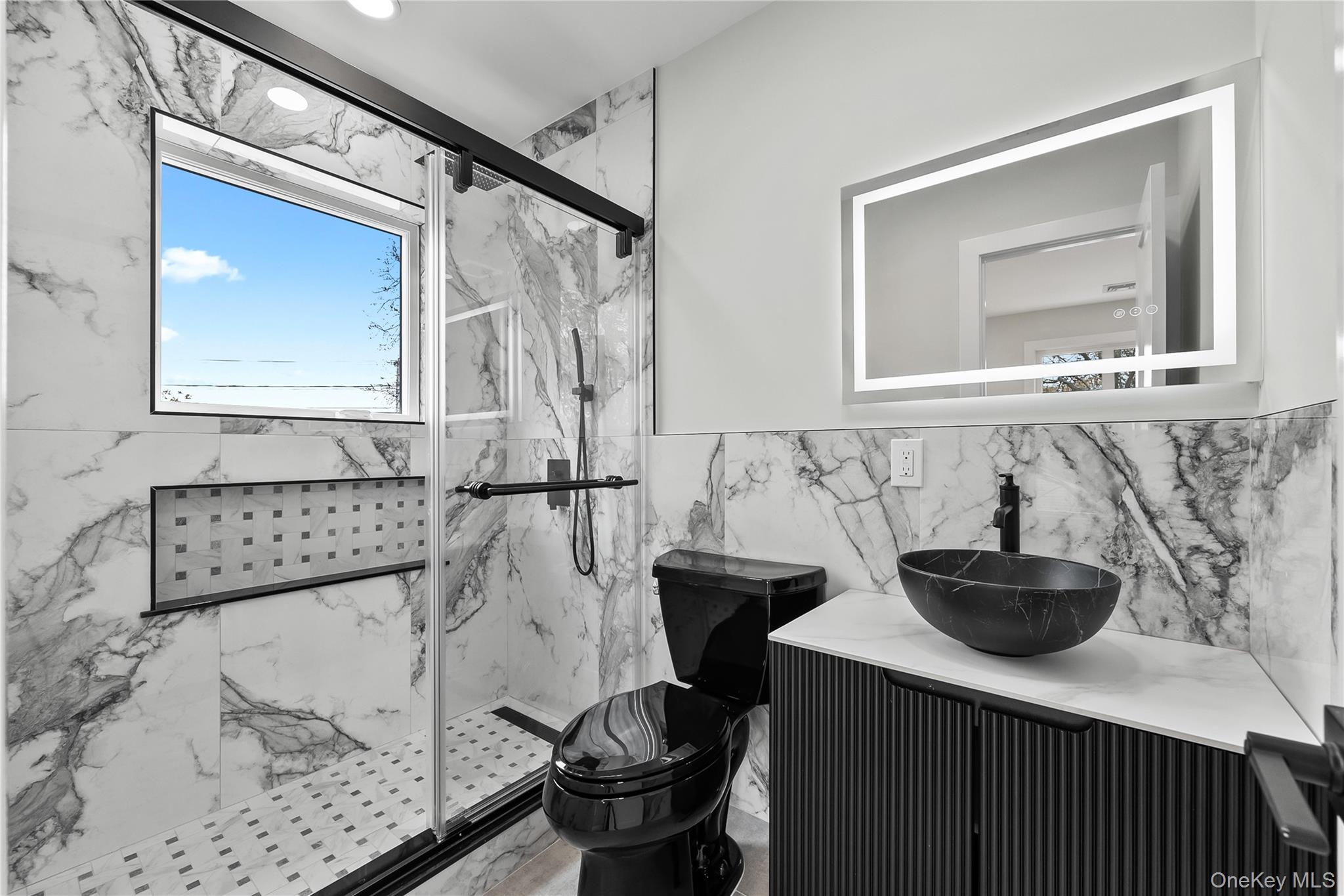 2 Orchid Road Levittown, NY 11756 - Photo 38 of 46 a bathroom with a sink and a mirror