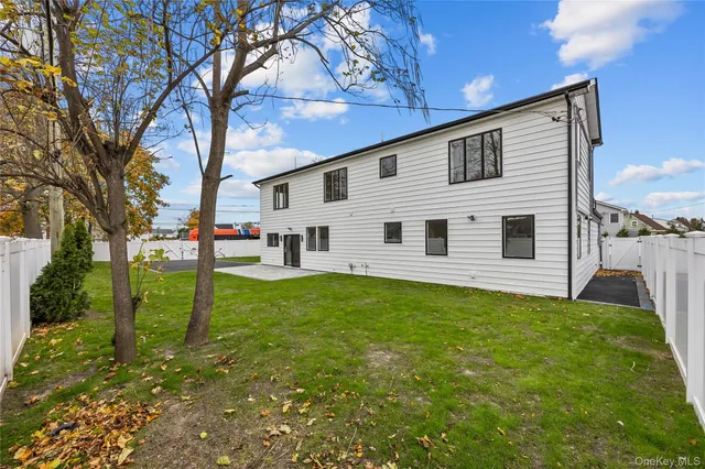 a view of a backyard with large trees