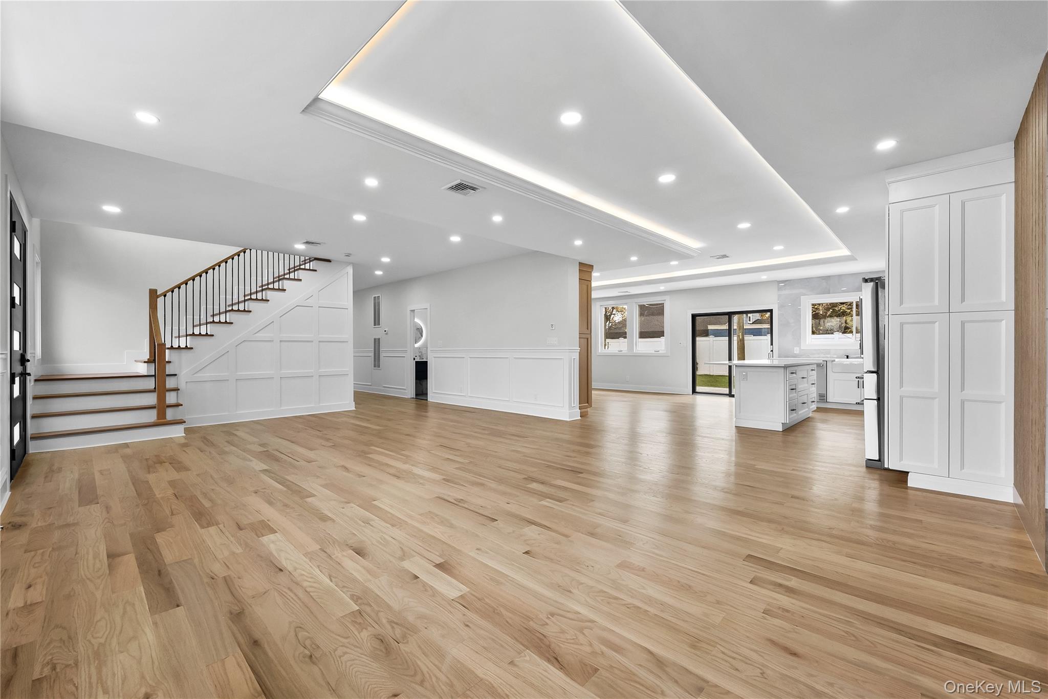2 Orchid Road Levittown, NY 11756 - Photo 6 of 46 a view of an empty room with wooden floor