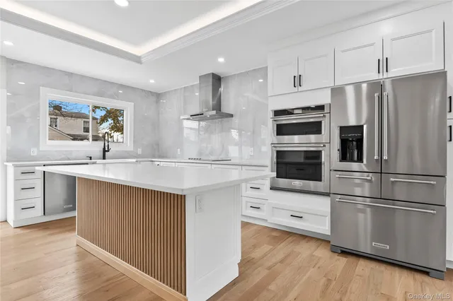 a kitchen with kitchen island a sink stainless steel appliances and cabinets