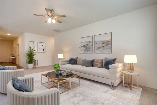 a living room with furniture and a chandelier