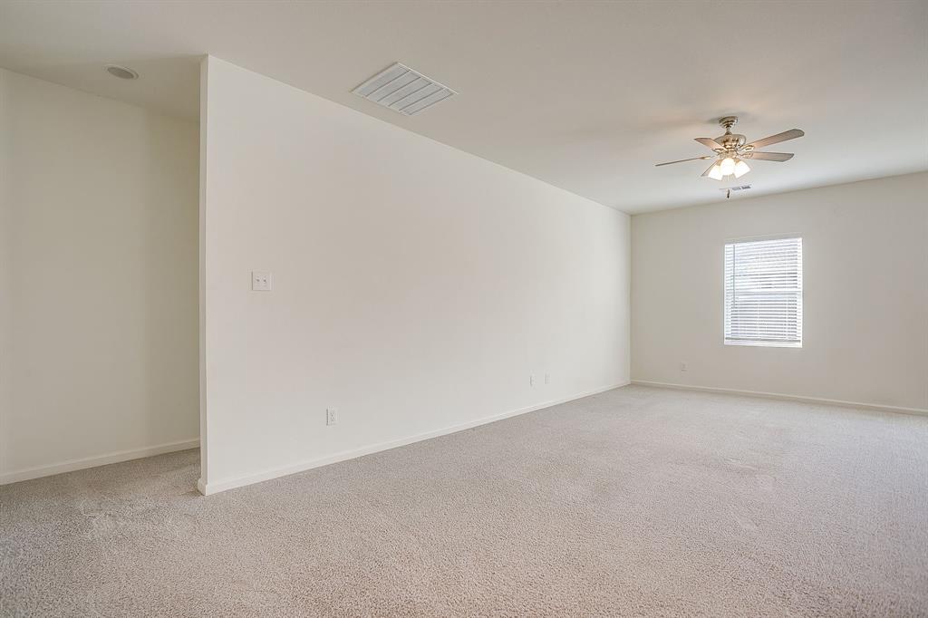 1405 Gentle Crk Lane Fort Worth, TX 76052 - Photo 12 of 40 an empty room with windows and fan