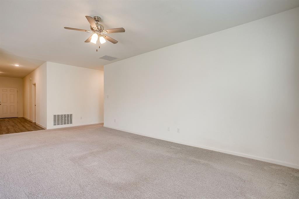 1405 Gentle Crk Lane Fort Worth, TX 76052 - Photo 15 of 40 a view of an empty room with a chandelier fan