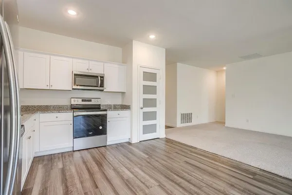 a kitchen with a refrigerator stove and microwave