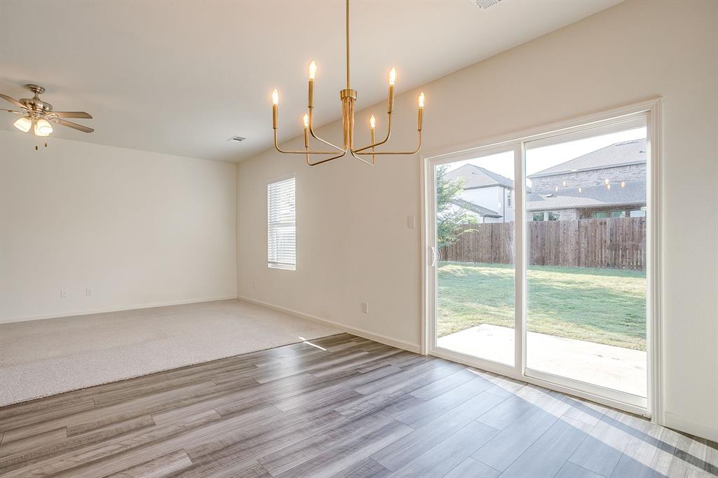 1405 Gentle Crk Lane Fort Worth, TX 76052 - Photo 18 of 40 a view of an empty room with wooden floor and a window