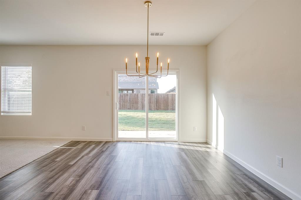 1405 Gentle Crk Lane Fort Worth, TX 76052 - Photo 19 of 40 a view of empty room with wooden floor and fan