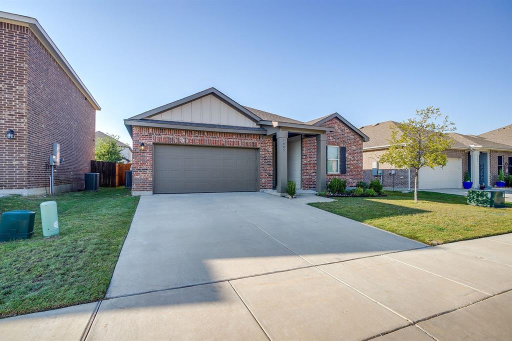 1405 Gentle Crk Lane Fort Worth, TX 76052 - Photo 2 of 40 a front view of a house with a yard and garage