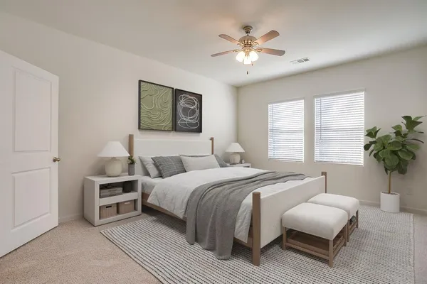 a bedroom with a bed and a chandelier