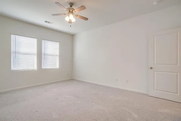 a view of room with a ceiling fan and window