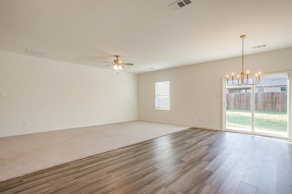 1405 Gentle Crk Lane Fort Worth, TX 76052 - Photo 24 of 40 a view of an empty room with wooden floor and a window