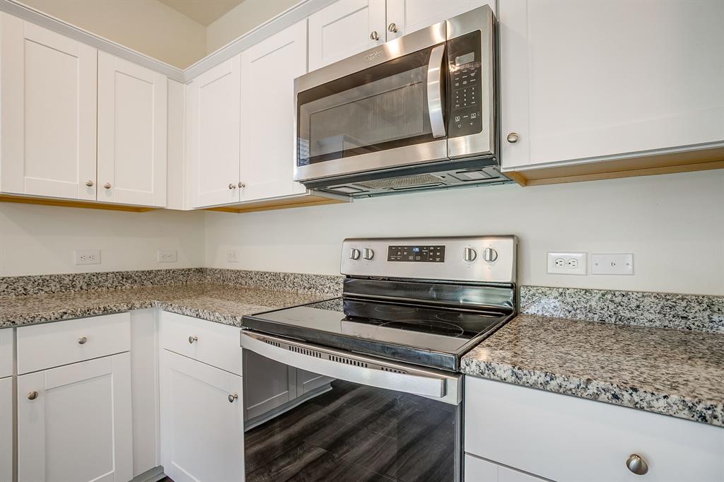 1405 Gentle Crk Lane Fort Worth, TX 76052 - Photo 25 of 40 a kitchen with stainless steel appliances granite countertop a stove microwave and cabinets