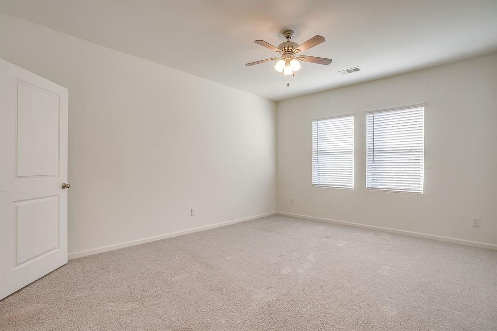 1405 Gentle Crk Lane Fort Worth, TX 76052 - Photo 26 of 40 an empty room with chandelier fan and windows