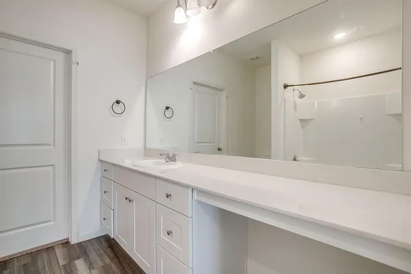 a bathroom with a double vanity sink and mirror