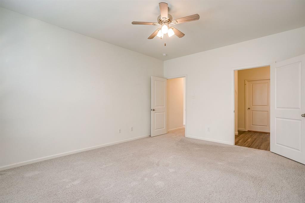 1405 Gentle Crk Lane Fort Worth, TX 76052 - Photo 28 of 40 an empty room with a ceiling fan and a window
